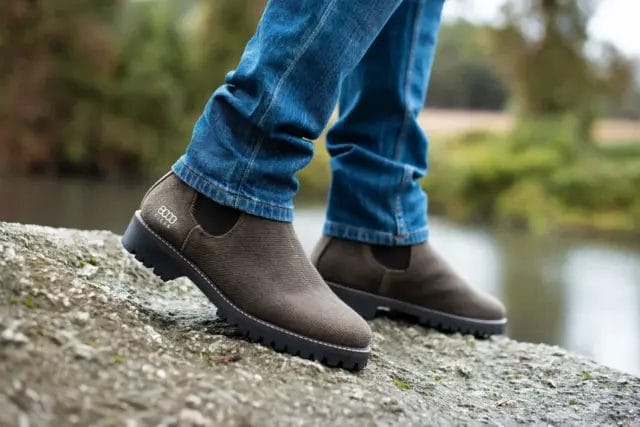 Photo of a man's feet outside wearing jeans and Hemp Chelsea Boot by 8000Kicks in dark brown