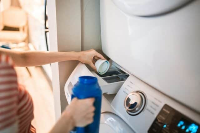 woman washing laundry in machine