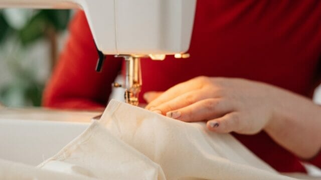 person sewing clothes