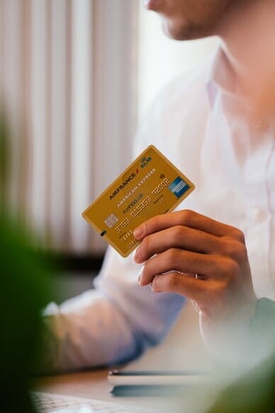 The power of consumer choices: a man's hand holding a credit card