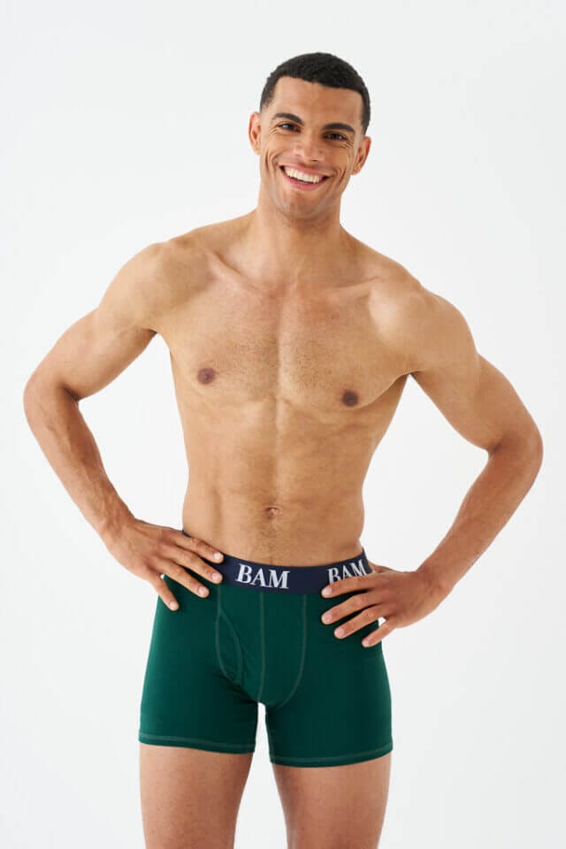 Man smiling wearing green boxer briefs from BAM
