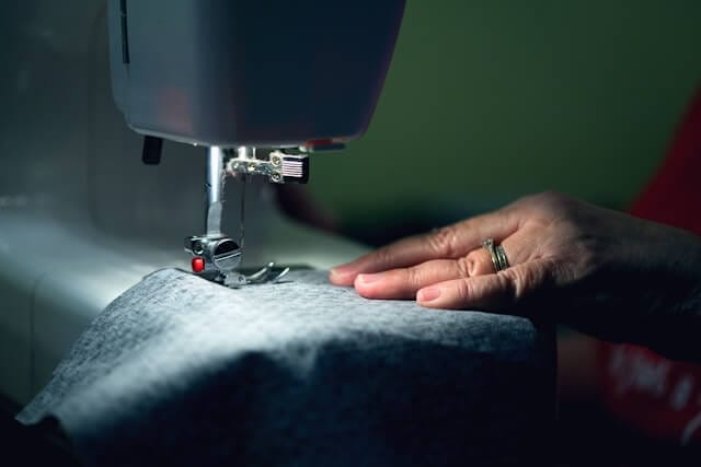 Outerknown Revolutionizing Fashion_person sewing clothes