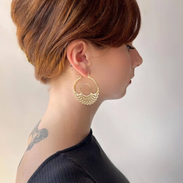 A model showcasing Astor and Orion's recyclable earring 