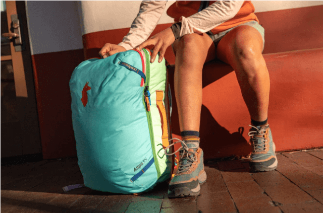 A model showcasing Cotopaxi's backpack 
