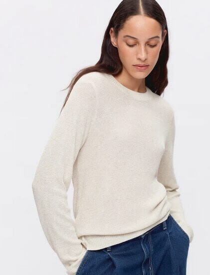 A model showcasing Kotn's white sweater