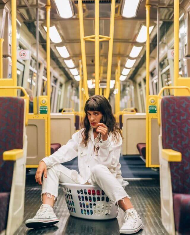 Woman in white jacket in a laundry basket with etiko shoes