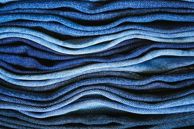 Denim jeans in a pile