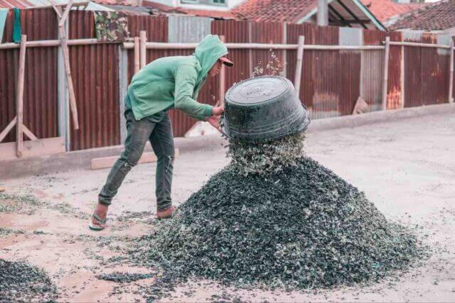 A man sorting recycled plastic at the processing facility