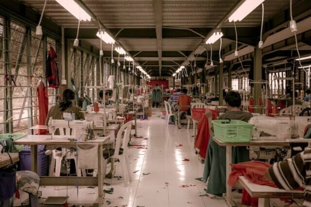 Series of sewing machines in a outsourced clothing factory.