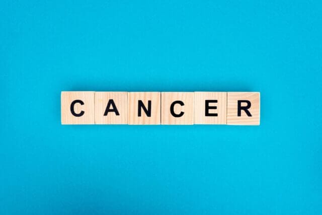 scrabble letters spell cancer