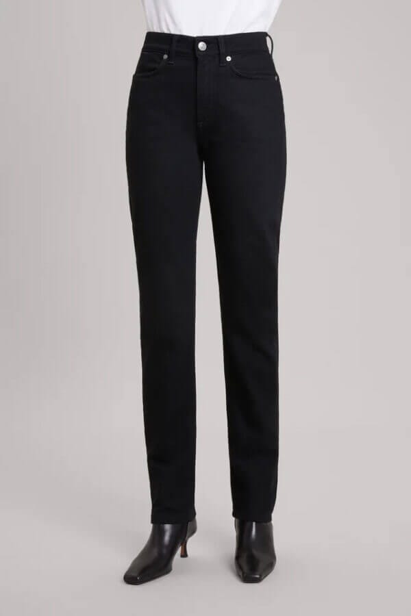 Lower half of a woman body wearing a black denim.