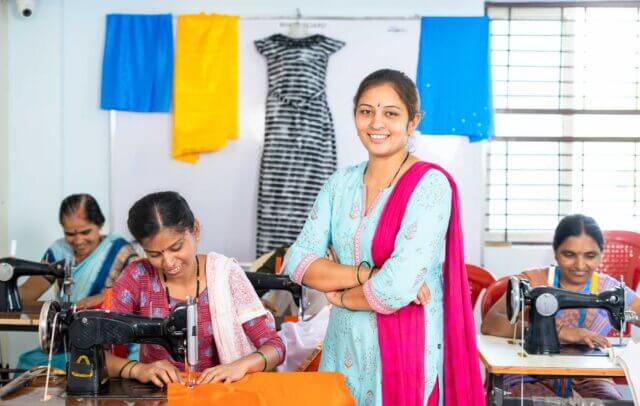 what is ethically manufactured clothing? Smiling female clothing maker standing with crossed arms