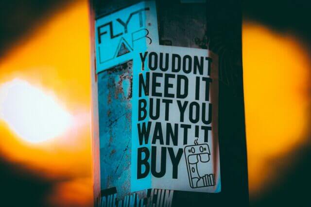 Poster suggesting that most consumerism comes from a want rather than a need.
