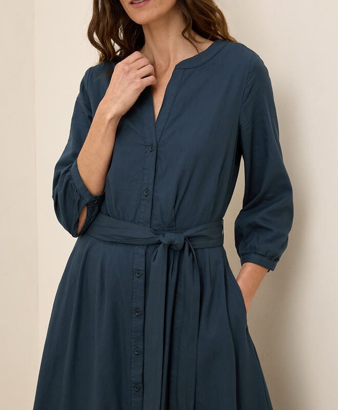 A hands up of a navy dress from Pact.