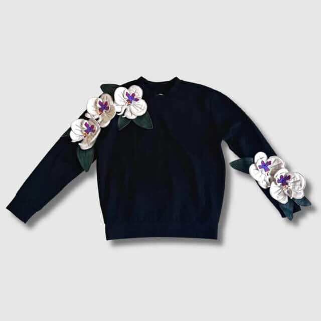 Hands up a black jumper with 3D flower details from Zero Waste Daniel.