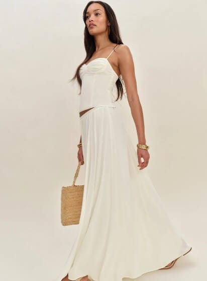 Reformation model wearing a sustainably made skirt and top.