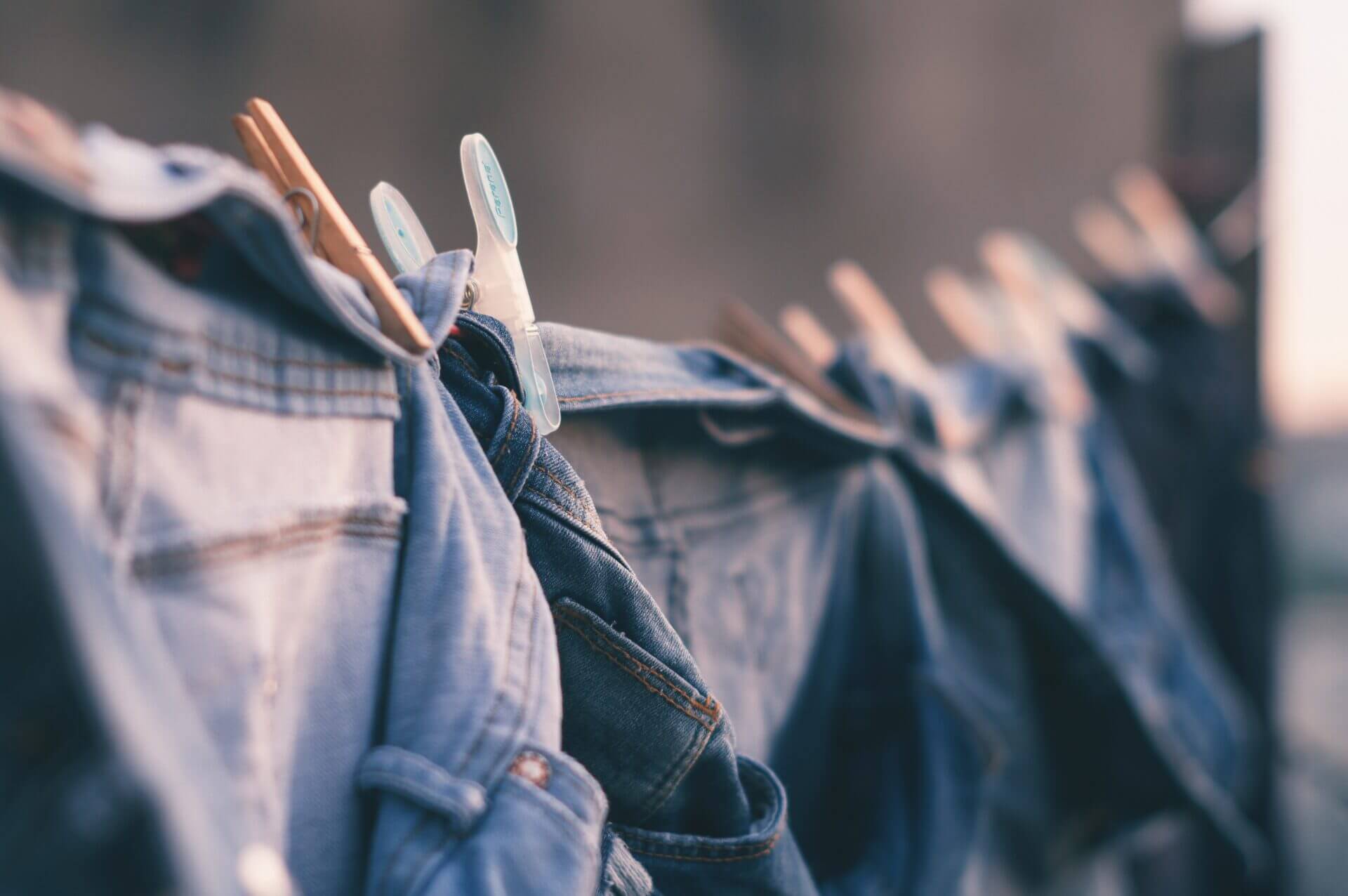A close-up of a denim product hanging out to dry.