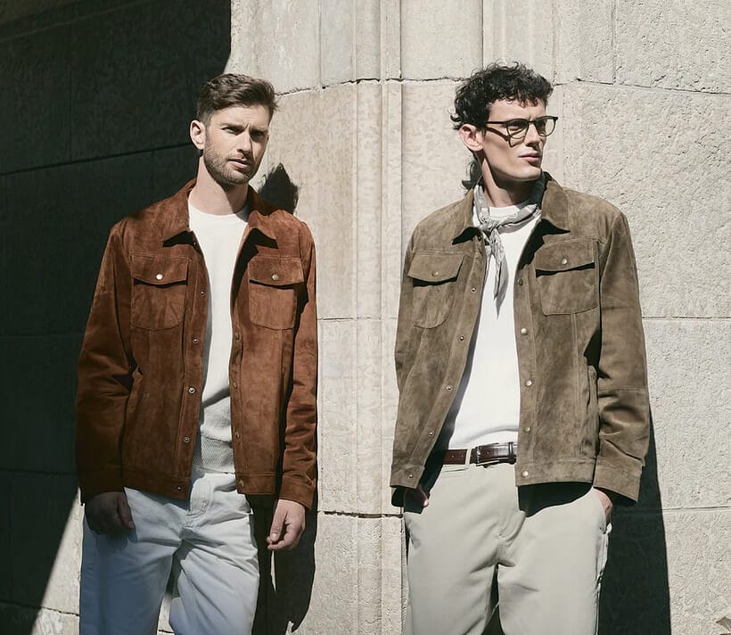 Two men standing, wearing suede jackets and denim.